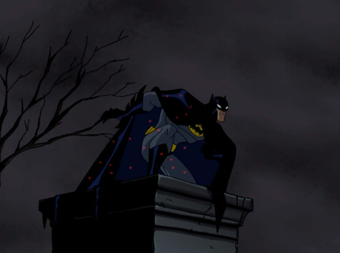 The Batman Vs Dracula 桌布 壁紙 — 蝙蝠俠棲息在石結構上，背景是黑暗風暴的天空，附近有光禿禿的樹枝剪影。