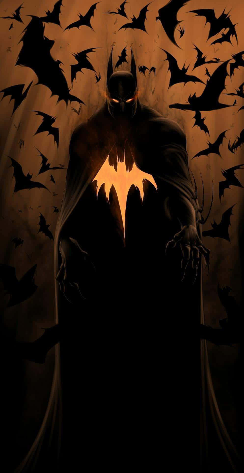 Batman The Long Halloween 桌布 壁紙 — 蝙蝠俠站在陰影中，發光的蝙蝠標誌，蝙蝠在他周圍飛舞，背景是溫暖的橙色。
