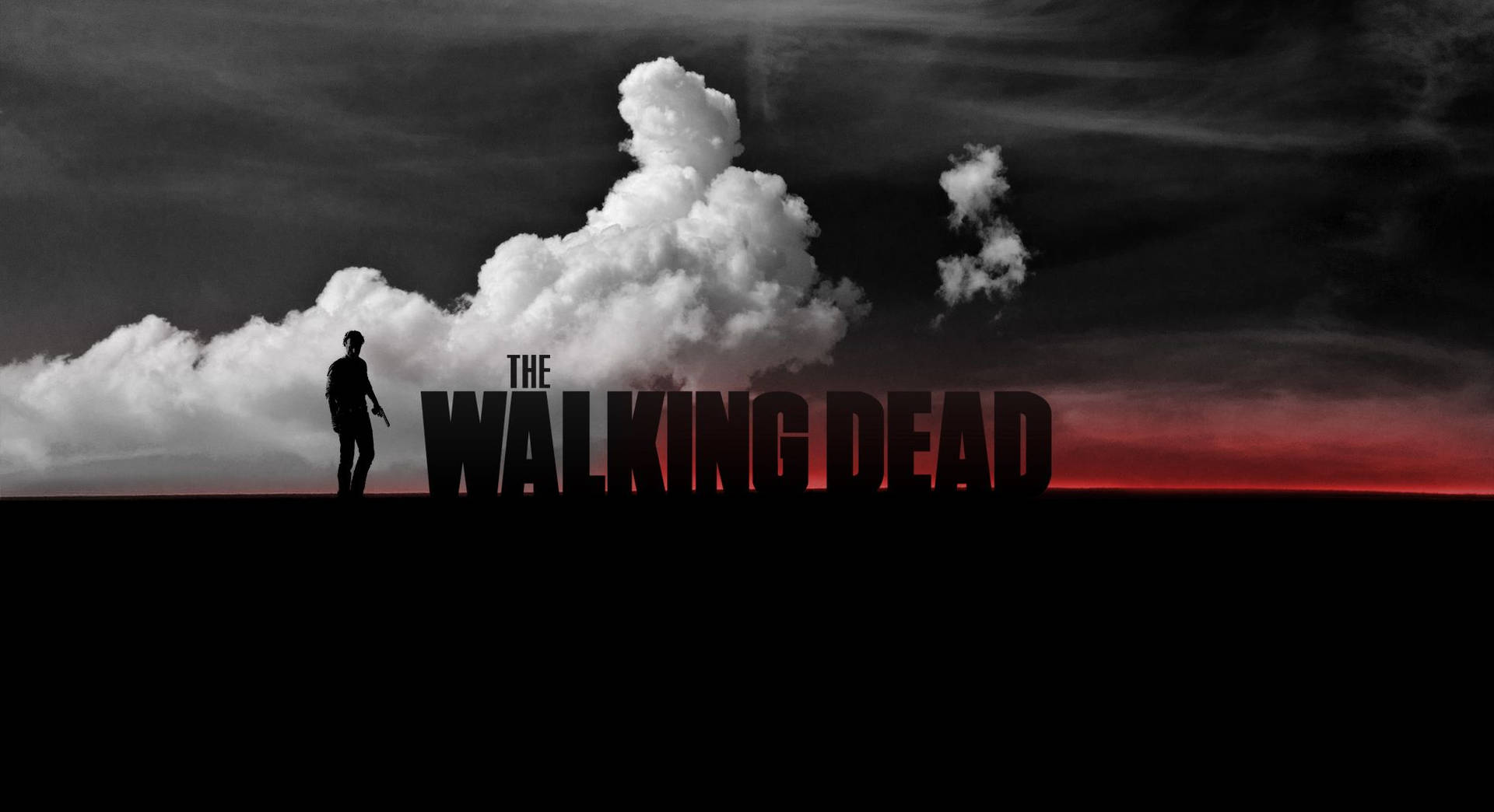 一個孤獨的人物站在紅色地平線前，有雲朵和標題《The Walking Dead》。 — 行屍走肉 GIF 壁紙