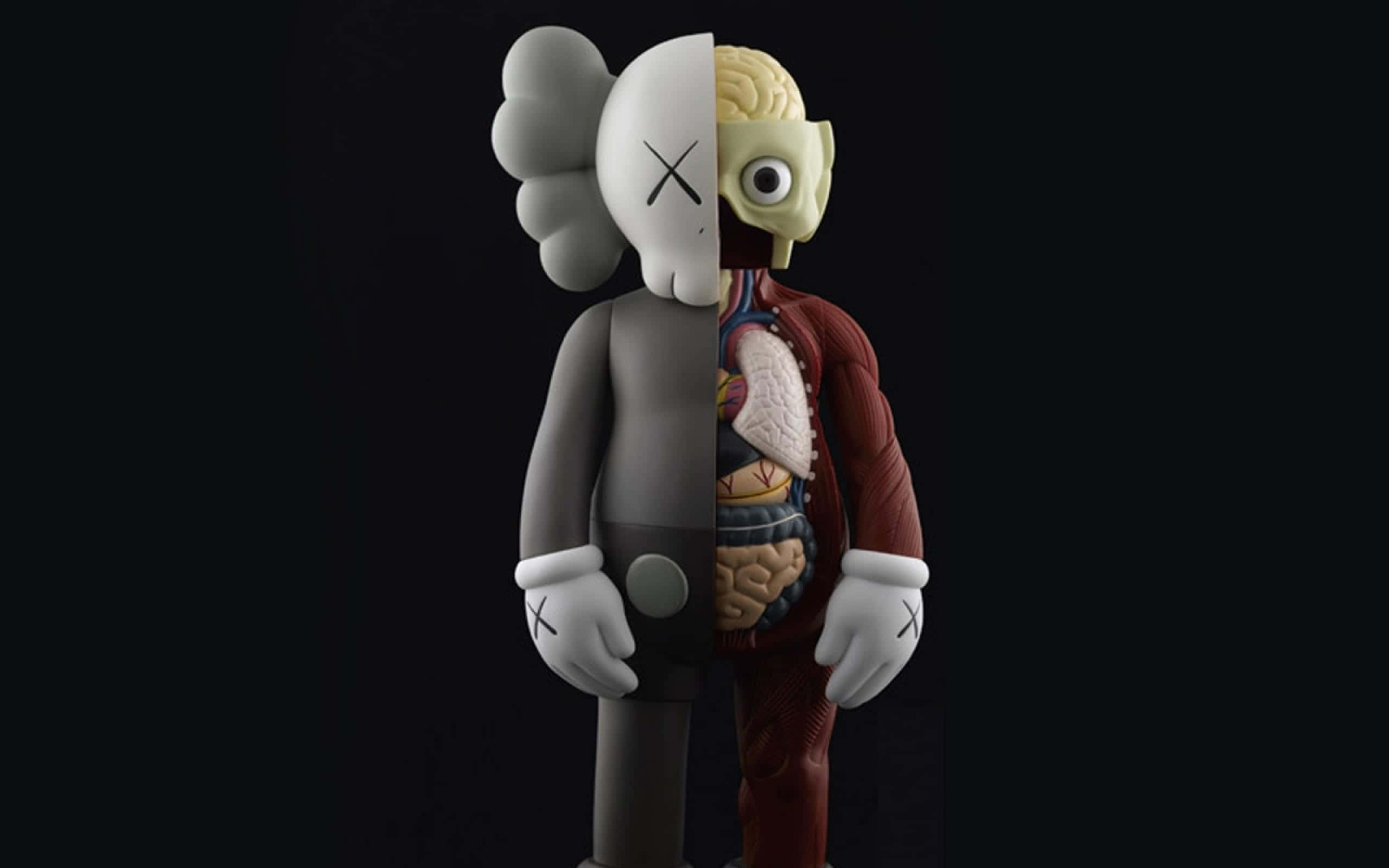 街頭藝術家KAWS 壁紙 — 一個分裂的KAWS公仔在黑色背景上露出內臟，一側顯示頭骨，另一側顯示大腦和心臟。