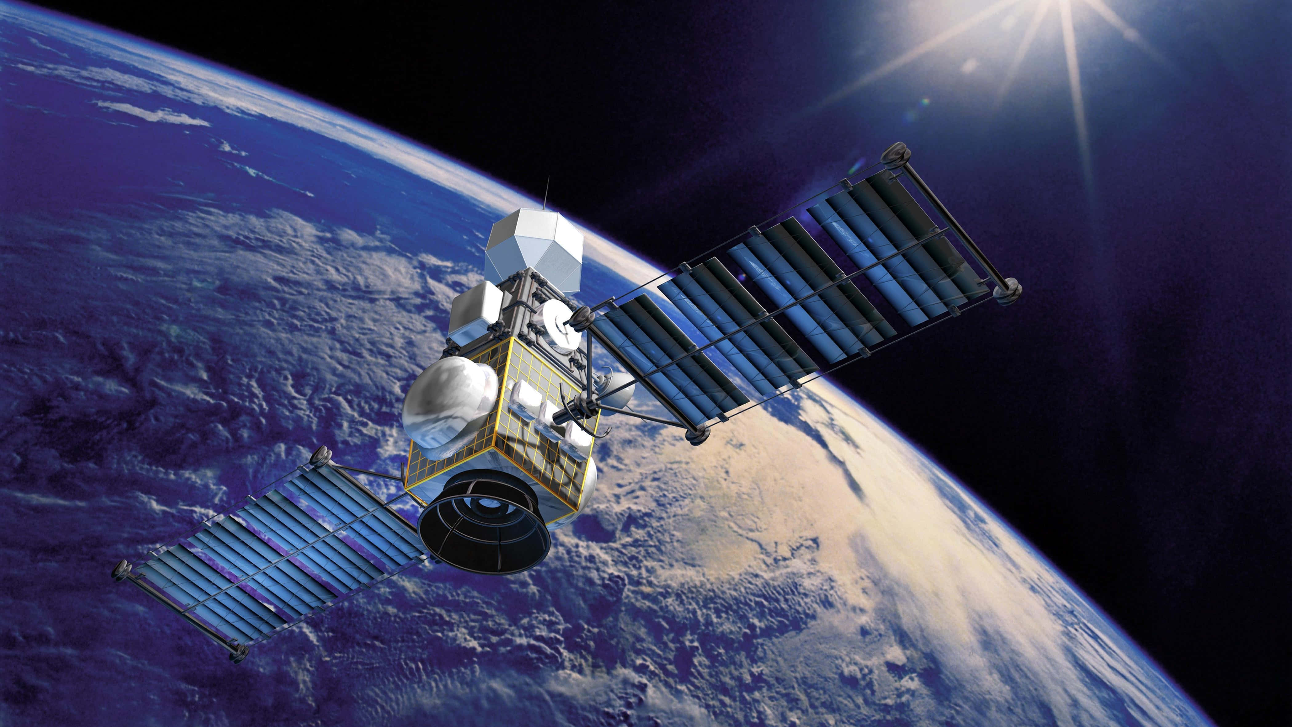 衛星穿越宇宙 壁紙 — 一個詳細的衛星在地球軌道上運行，太陽能板展開，背景是發光的太陽和藍色星球。