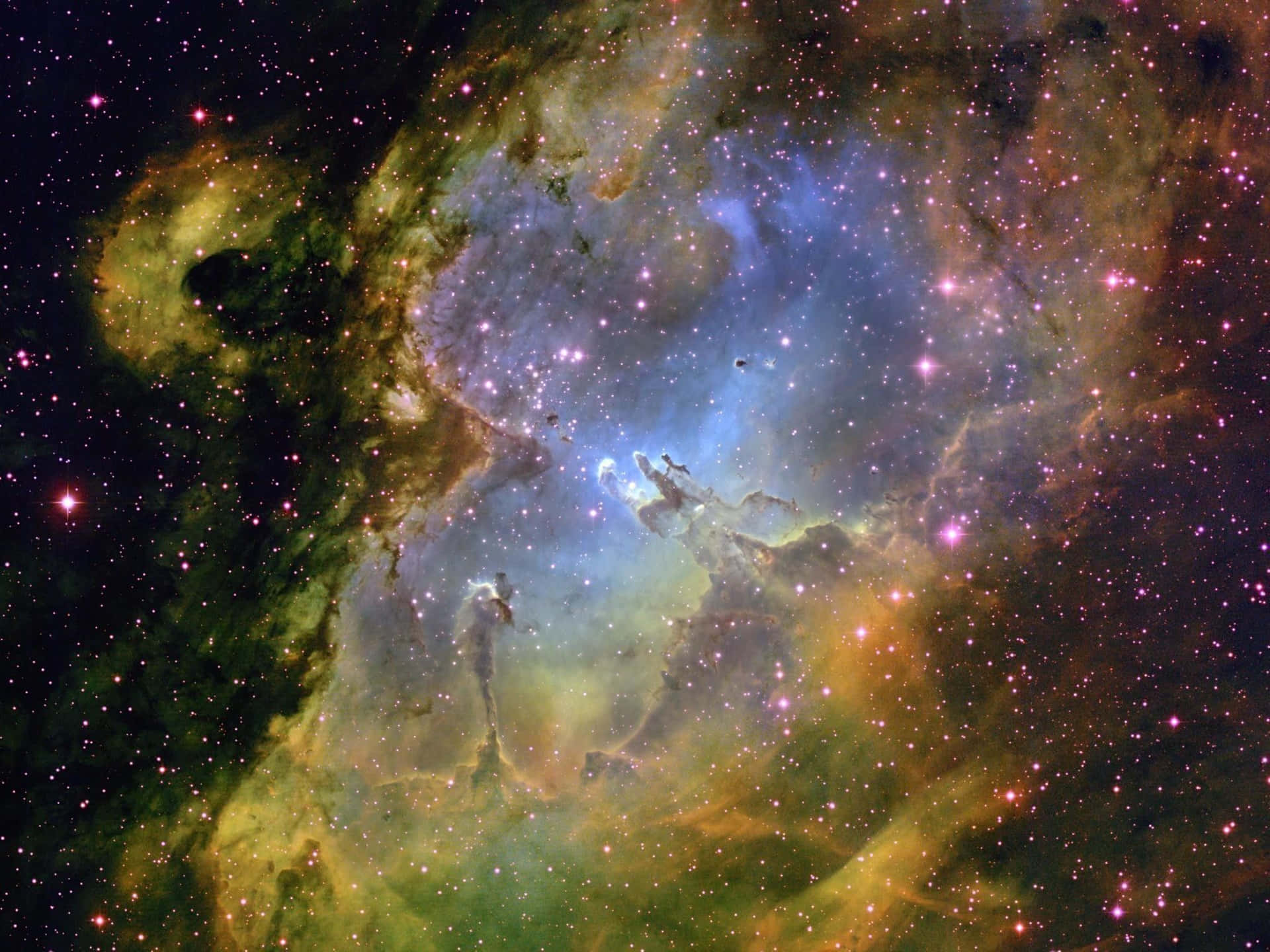 一個色彩繽紛的星雲，充滿了星星和發光的氣體雲，在深空中。