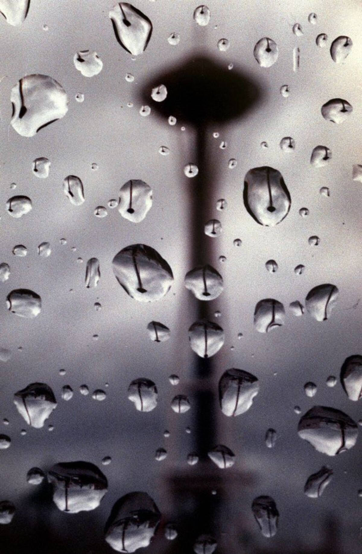 窗戶上的雨滴，背景是模糊的太空針塔輪廓。