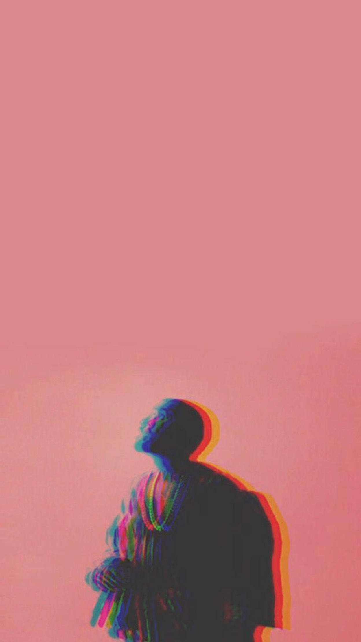 說唱歌手德雷克酷炫iPhone設計 壁紙 — 一個帶有彩虹故障效果的人站在純粉紅色背景前，頭部向上傾斜，呈現沉思姿態。