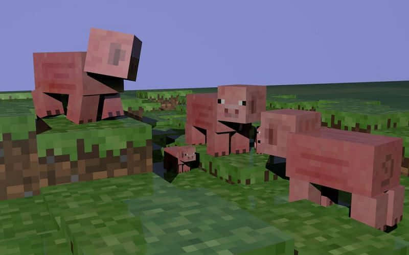 Minecraft世界中的四隻像素化豬在草地上