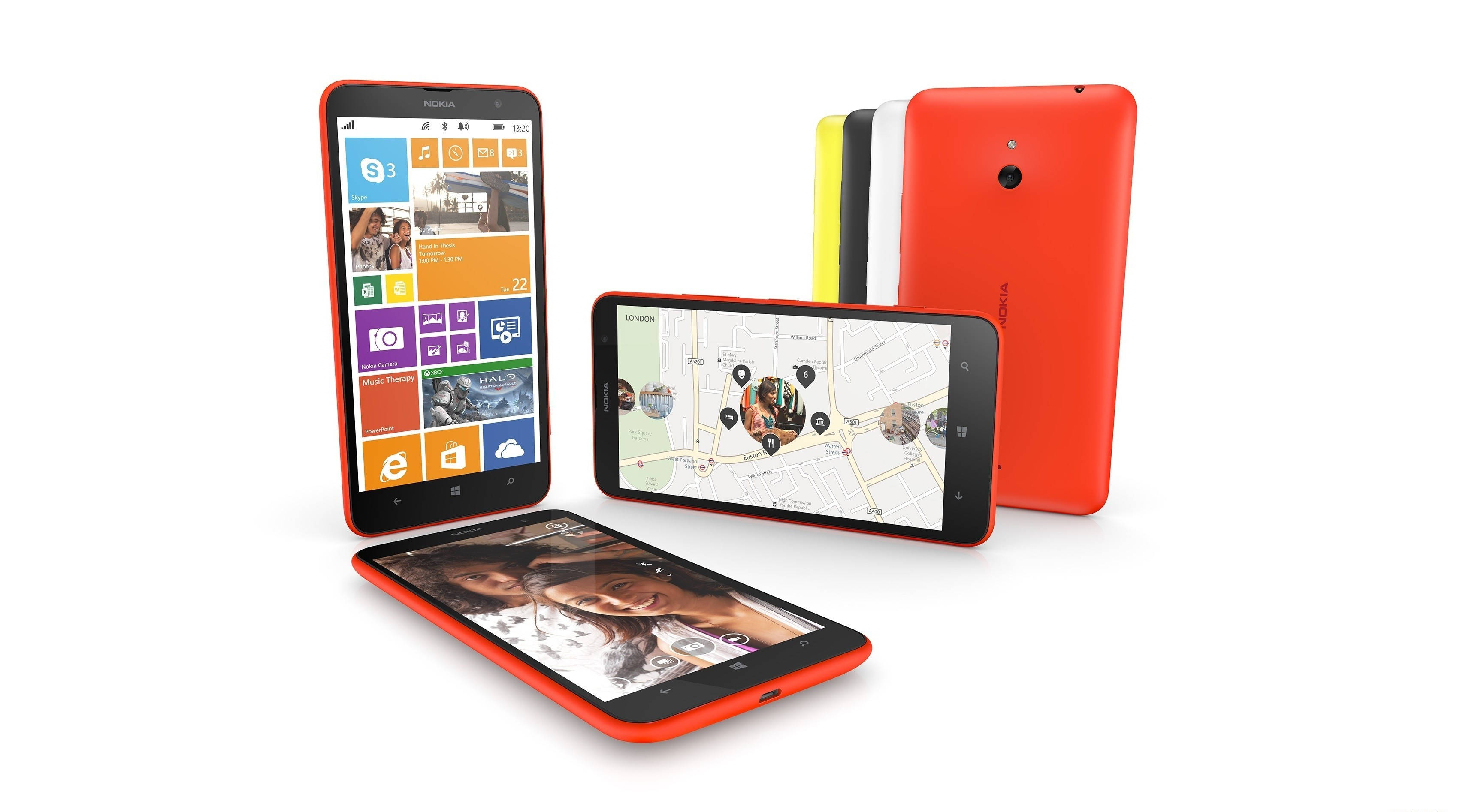 諾基亞 Lumia 1320 大螢幕手機 壁紙 — 四部色彩繽紛的Nokia Lumia智能手機以不同角度展示，呈現充滿活力的Windows Phone介面，背景為純白色。