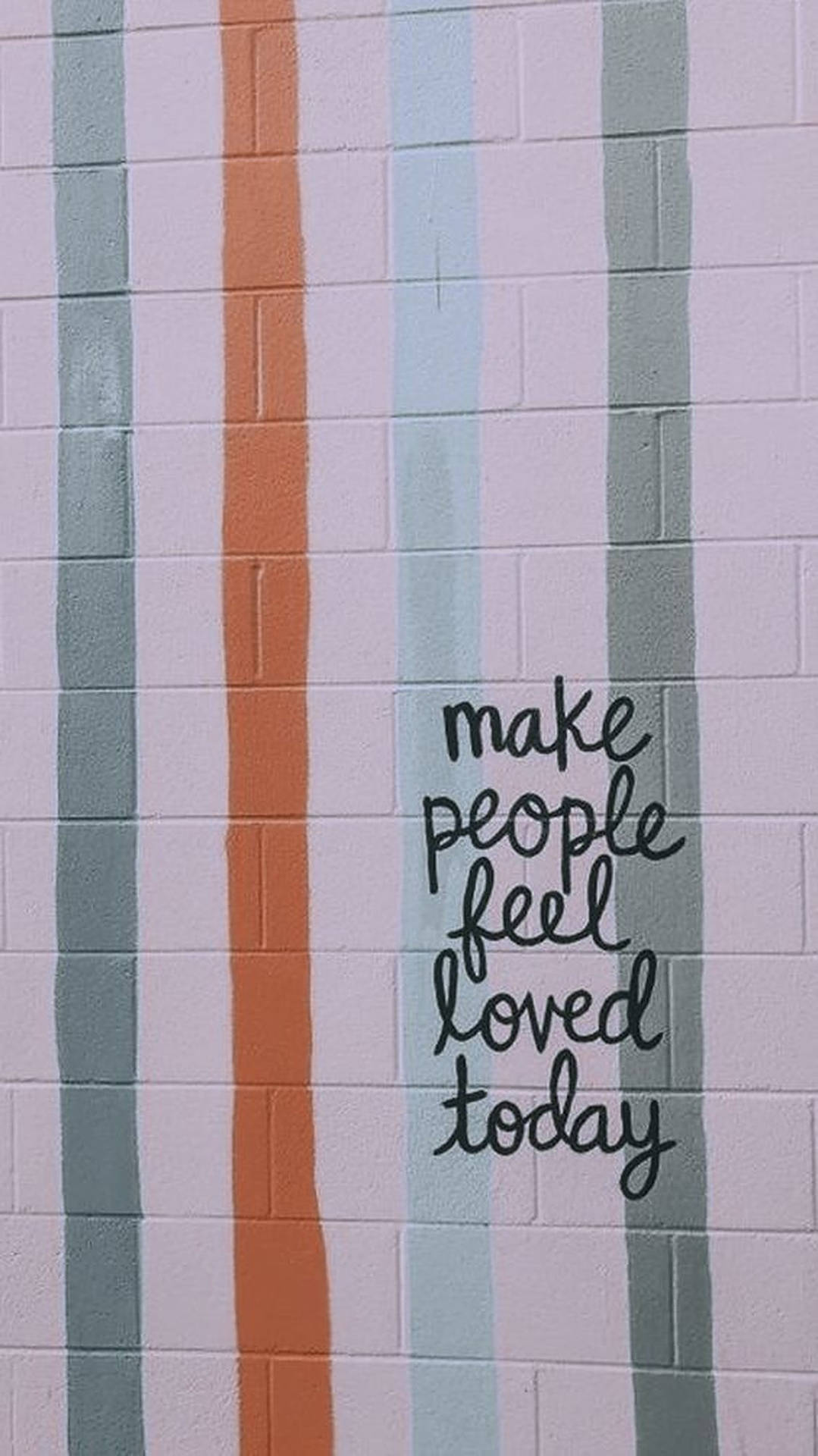 粉彩條紋磚牆，帶有手寫勵志語句 make people feel loved today
