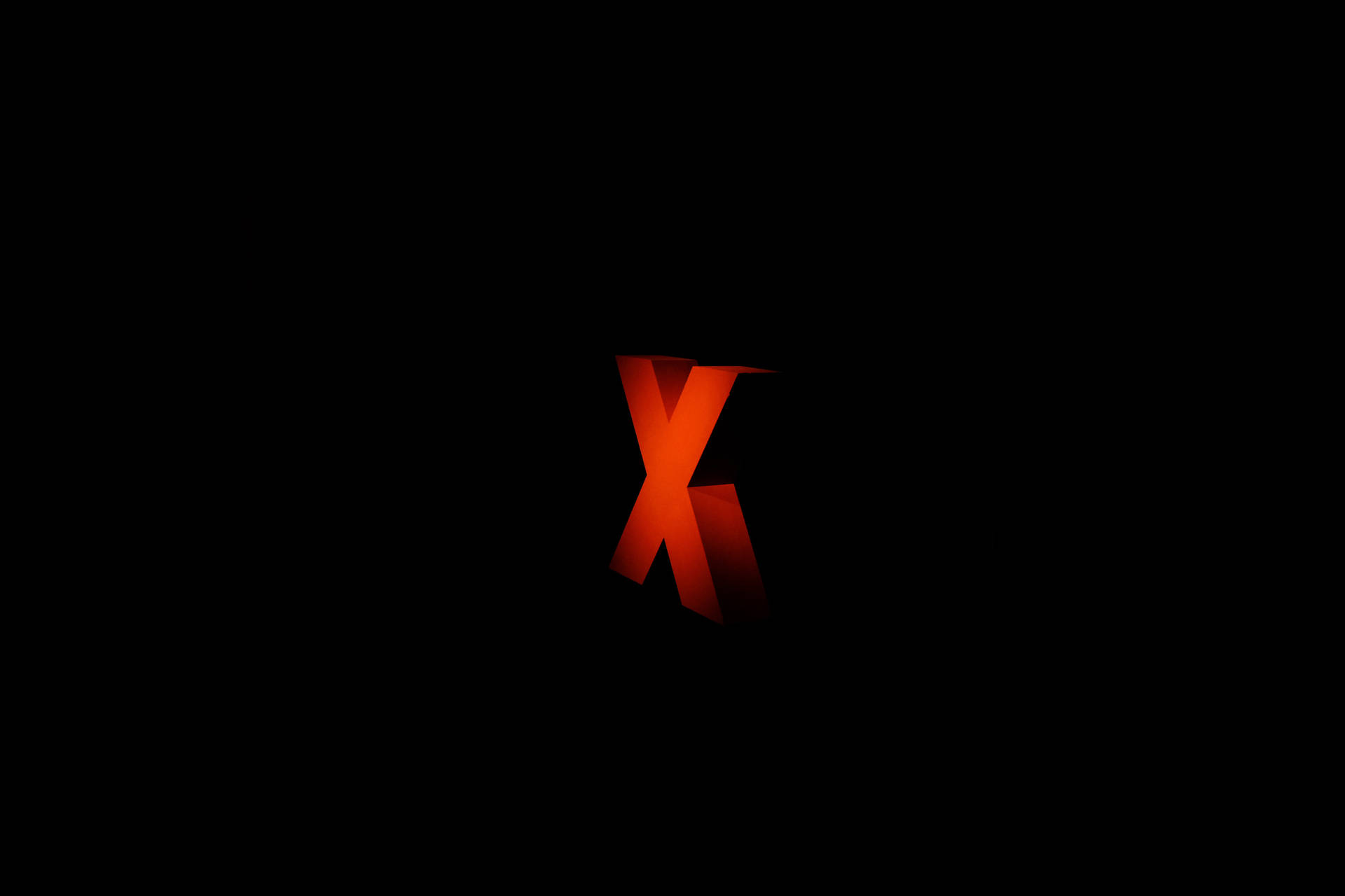 一個發光的紅色3D字母X在黑色背景上。