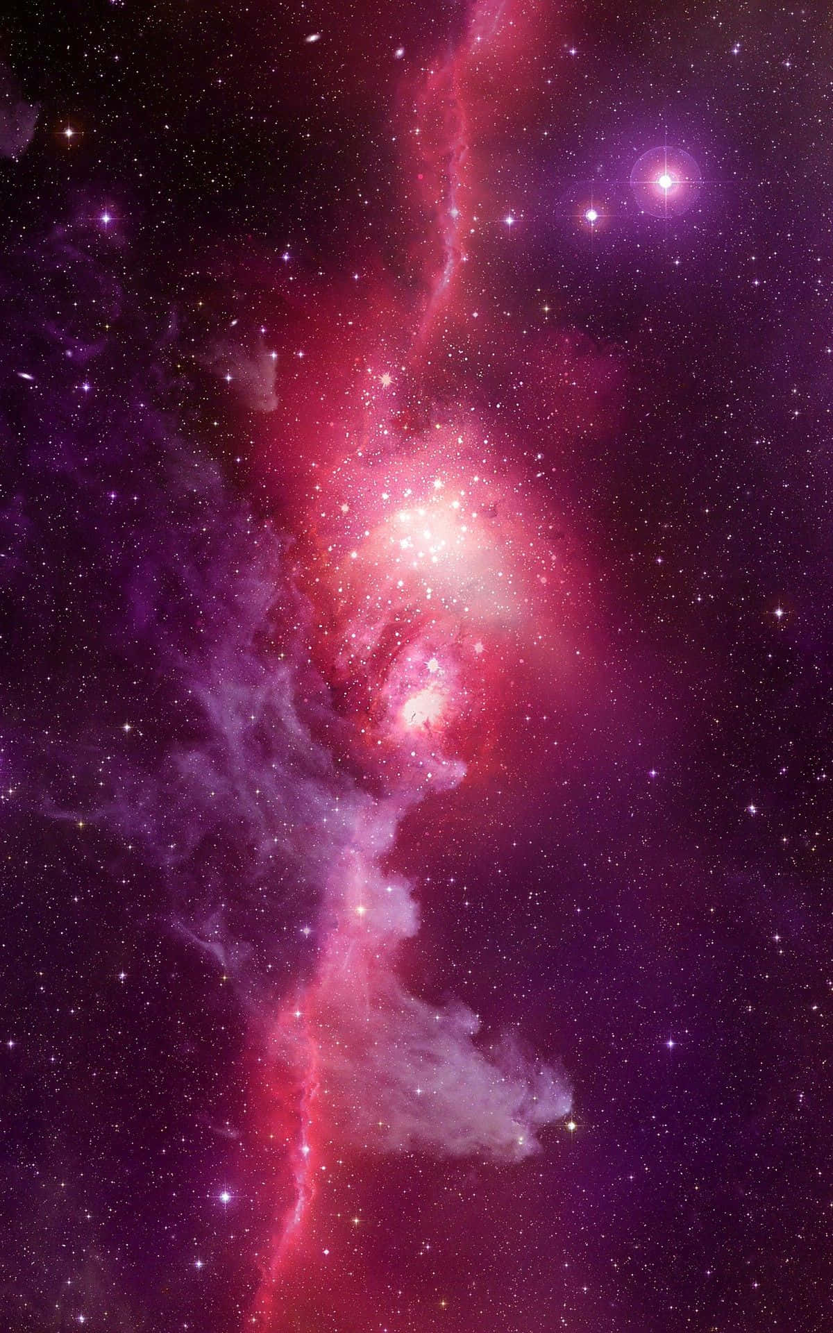 深空中帶有閃爍恆星的鮮豔粉紅和紫色星雲。