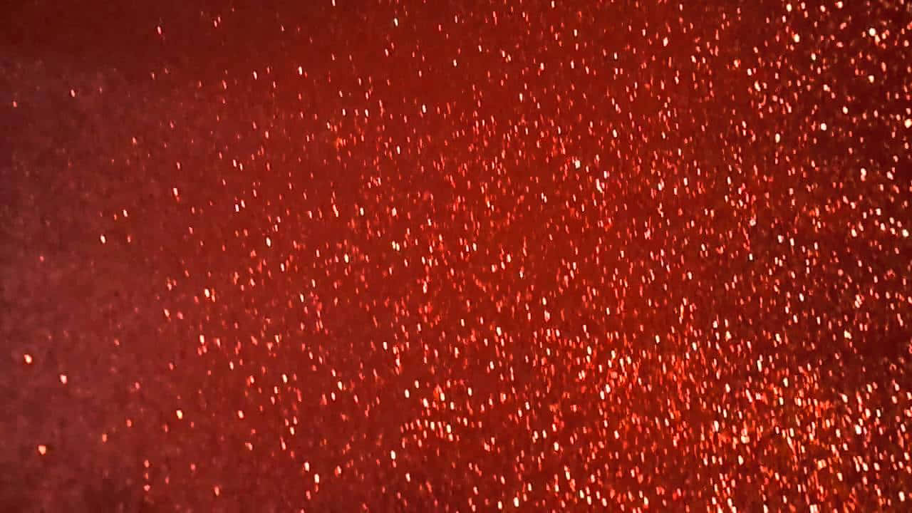 帶有閃爍顆粒的紅色閃粉表面