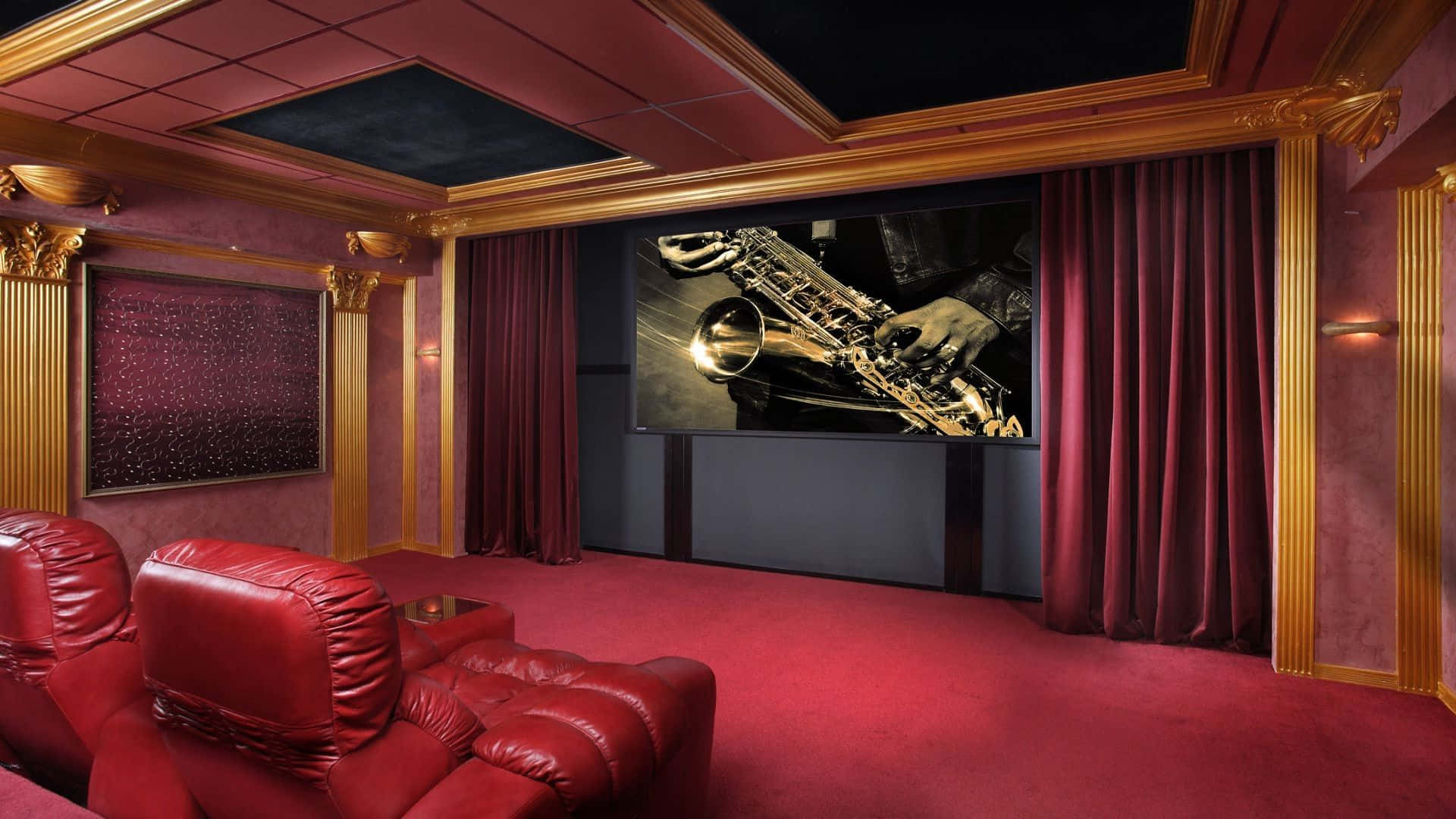 Home Cinema 桌布 壁紙 — 豪華家庭影院，配有紅色皮革躺椅、金色飾邊和大屏幕，顯示戲劇性燈光下的薩克斯風演奏者。