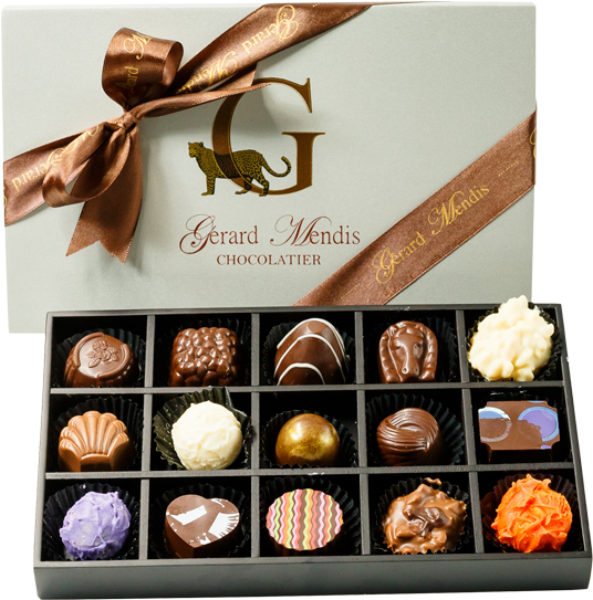 豪華綜合巧克力禮盒 壁紙 — 來自Gerard Mendis Chocolatier的優雅朱古力盒，內有各式美食松露朱古力，置於時尚黑色托盤上。