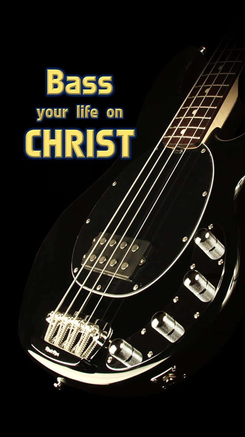 黑色低音結他，帶有發光文字「Bass your life on CHRIST」，背景為深色