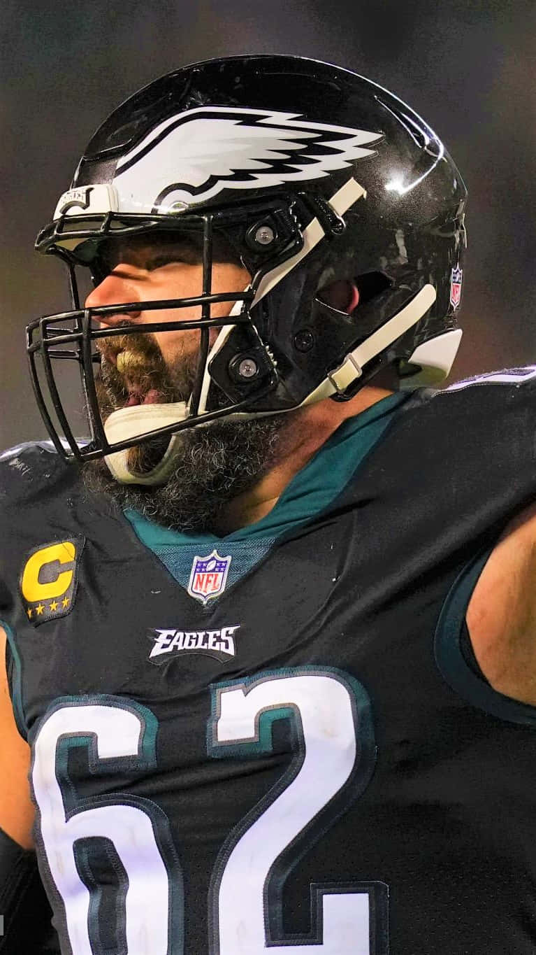 Jason Kelce 桌布 壁紙 — 費城老鷹隊美式足球員留鬍鬚，在夜間比賽中戴著頭盔咆哮的特寫。