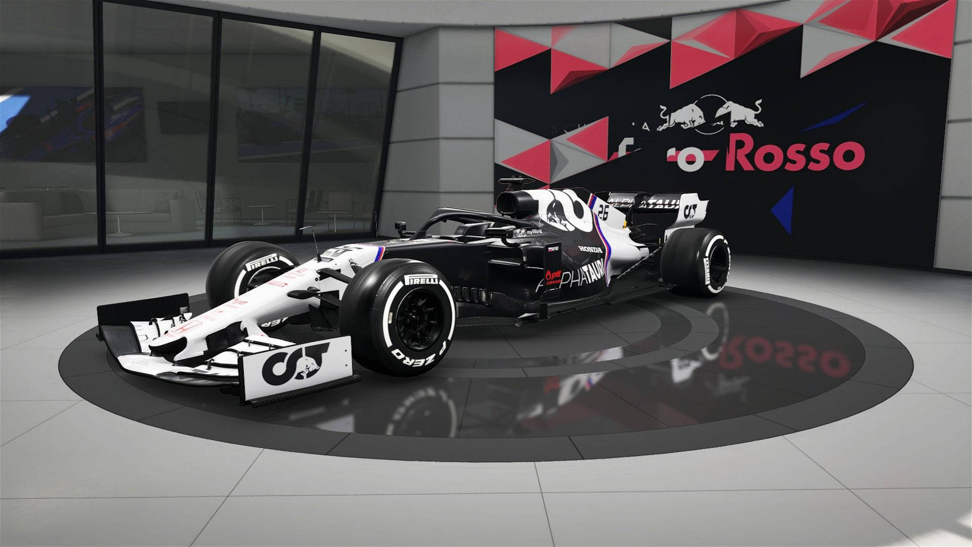帶有 Red Bull 品牌標誌的黑白一級方程式賽車在現代展廳中展示。