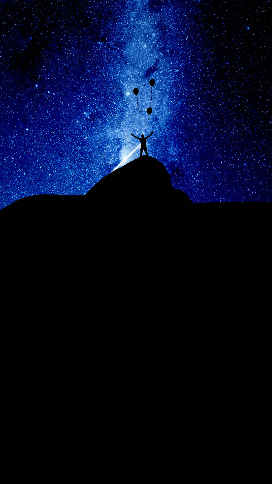 人在山頂上在星空下釋放氣球