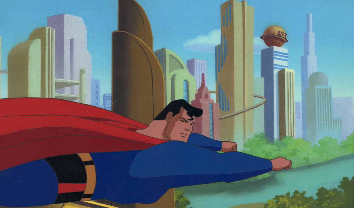 Superman The Animated Series 桌布 壁紙 — 超人喺晴朗藍天背景下，喺風格化城市景觀上空翱翔，紅色斗篷喺佢身後飄揚。