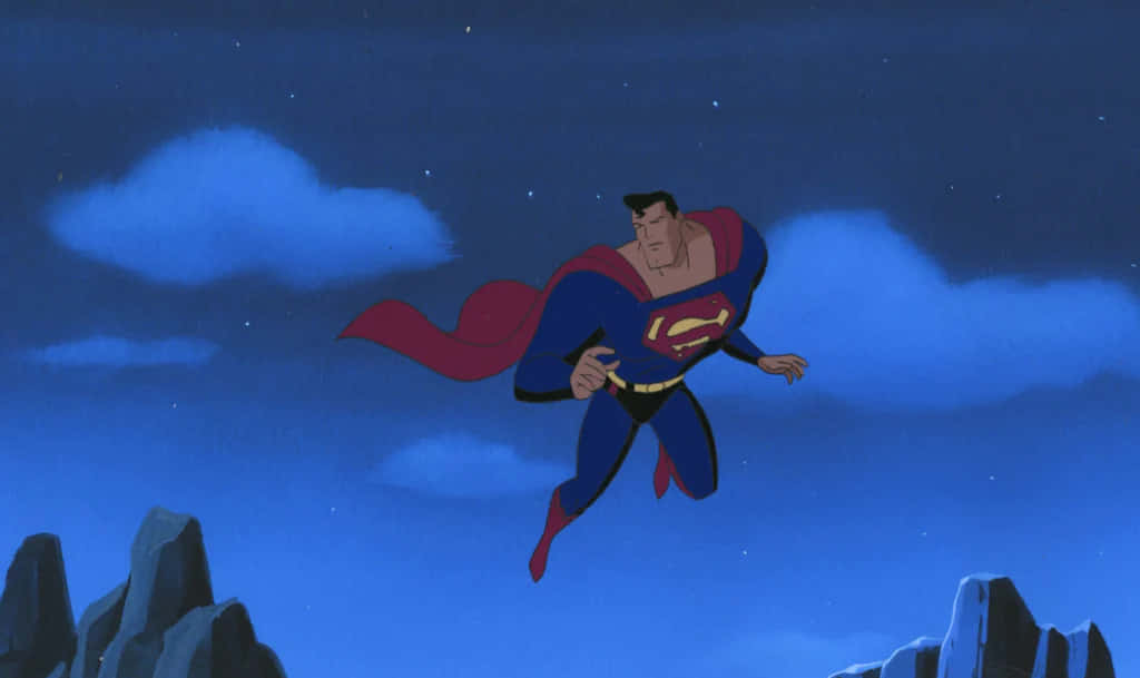 Superman The Animated Series 桌布 壁紙 — 超人喺繁星夜空翱翔，斗篷喺崎嶇山頂上飄揚。