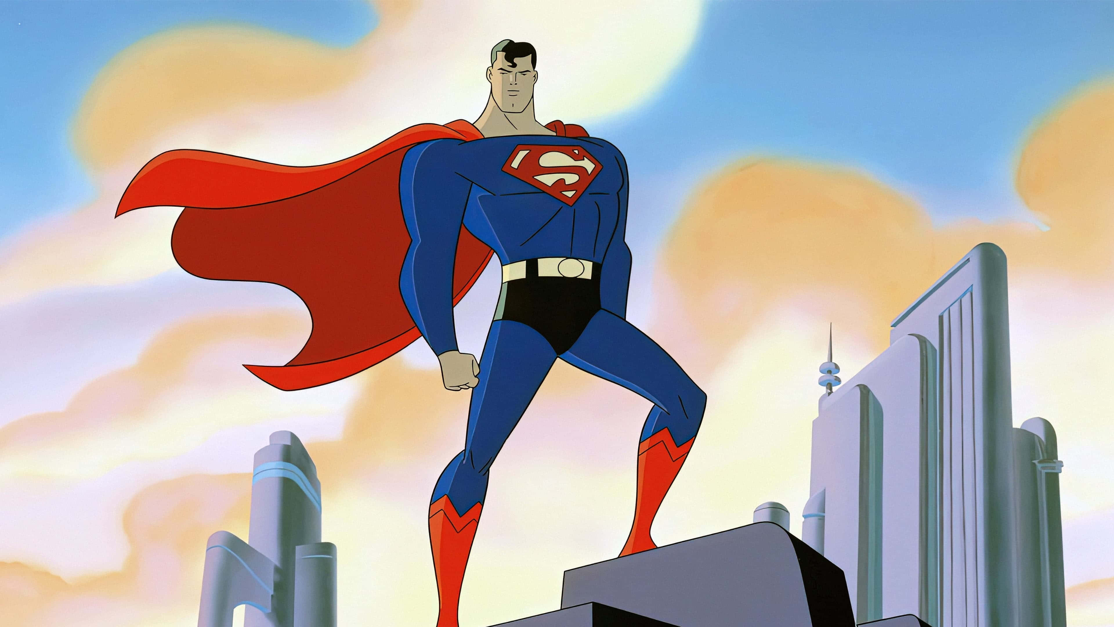 Superman The Animated Series 桌布 壁紙 — 超人英雄地站在摩天大樓頂端，紅色斗篷在夕陽天空下飄揚。
