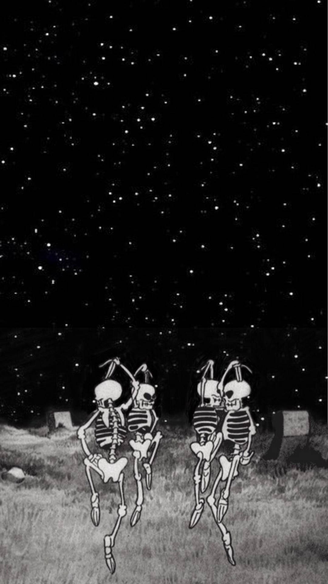 兩個跳舞的骷髏在星空下的墓園裡。
