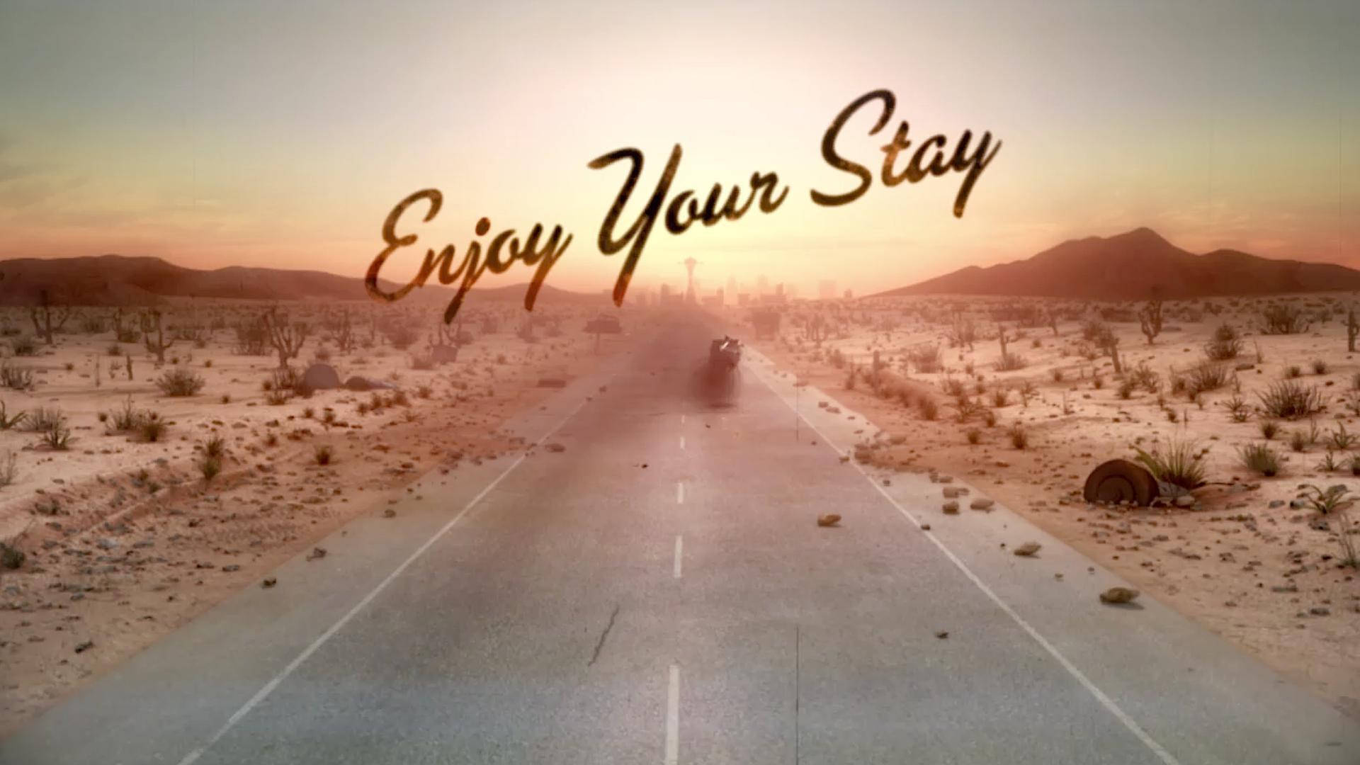 日落時分沙漠公路上的電單車，上方有「Enjoy Your Stay」文字。