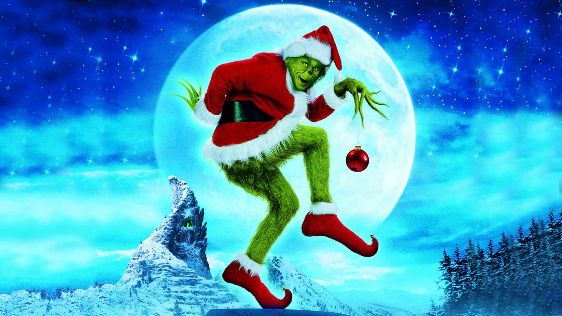 Christmas Movie 桌布 壁紙 — 身穿紅色聖誕老人服的鬼靈精，在滿月背襯的星空下歡快地跳躍。