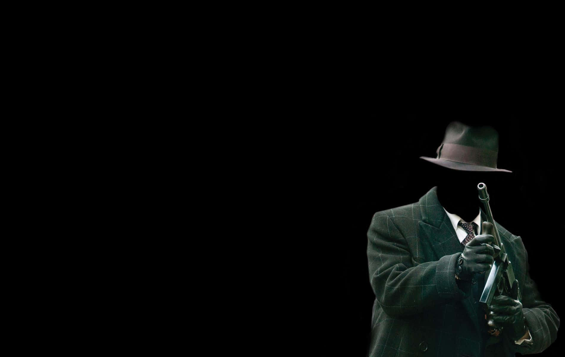 身穿西裝戴帽的男人持槍 壁紙