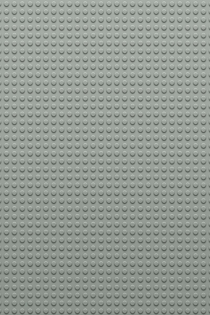 灰色LEGO底板，帶有重複的圓形凸點用於搭建。