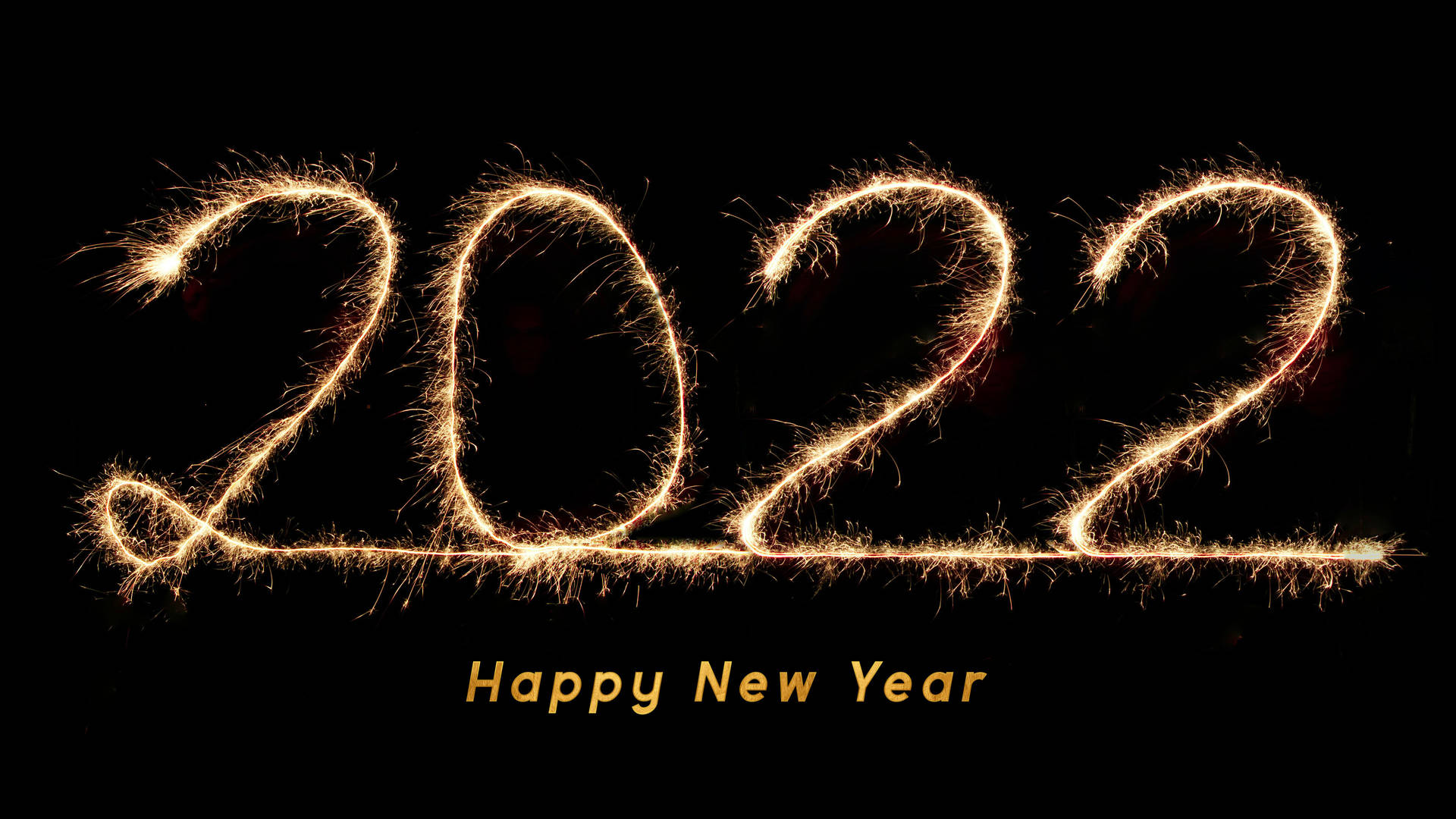 金色火花拼出2022，黑色背景下方有「Happy New Year」文字。