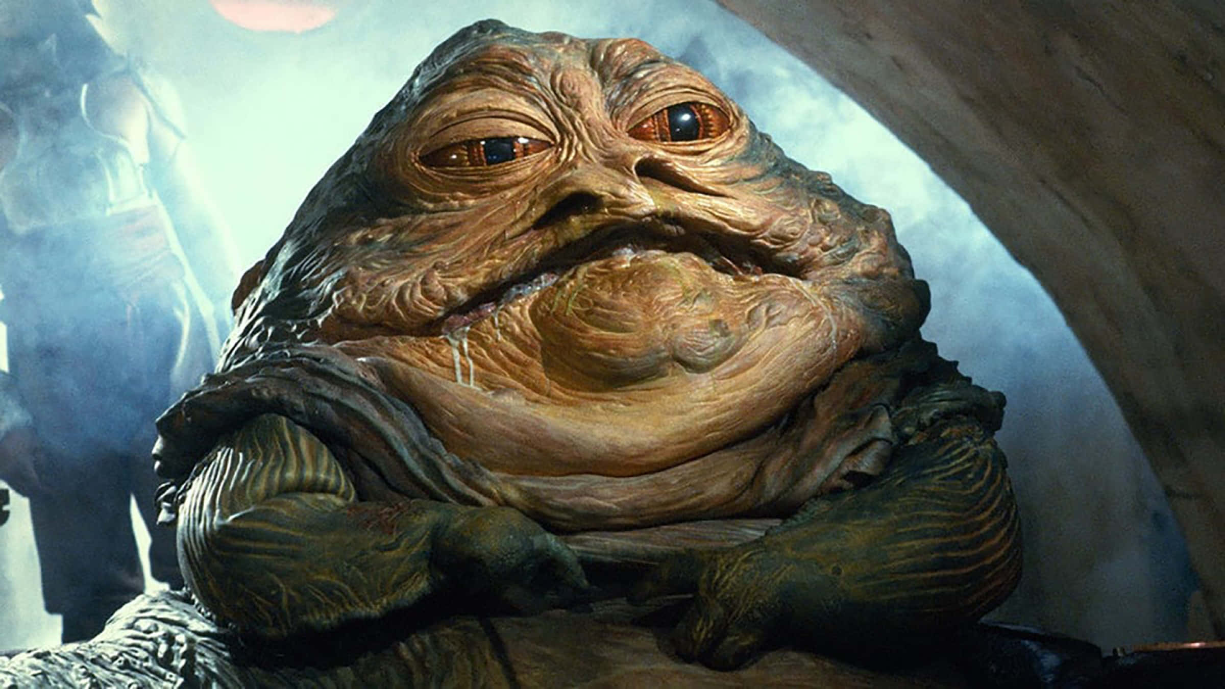 A New Hope 桌布 壁紙 — 近距離拍攝怪誕、皺紋滿佈且呈球根狀的Jabba the Hutt，帶有發光的橙色眼睛和自鳴得意的表情。