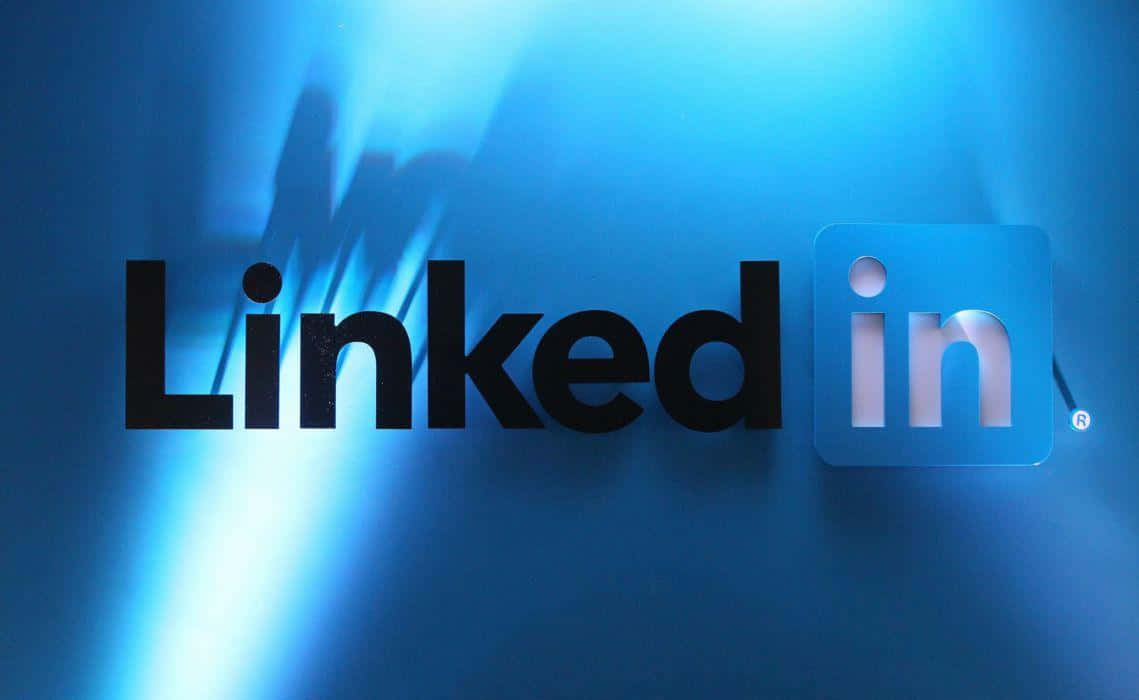 LinkedIn標誌在帶有光線條紋的藍色漸變牆上發光。