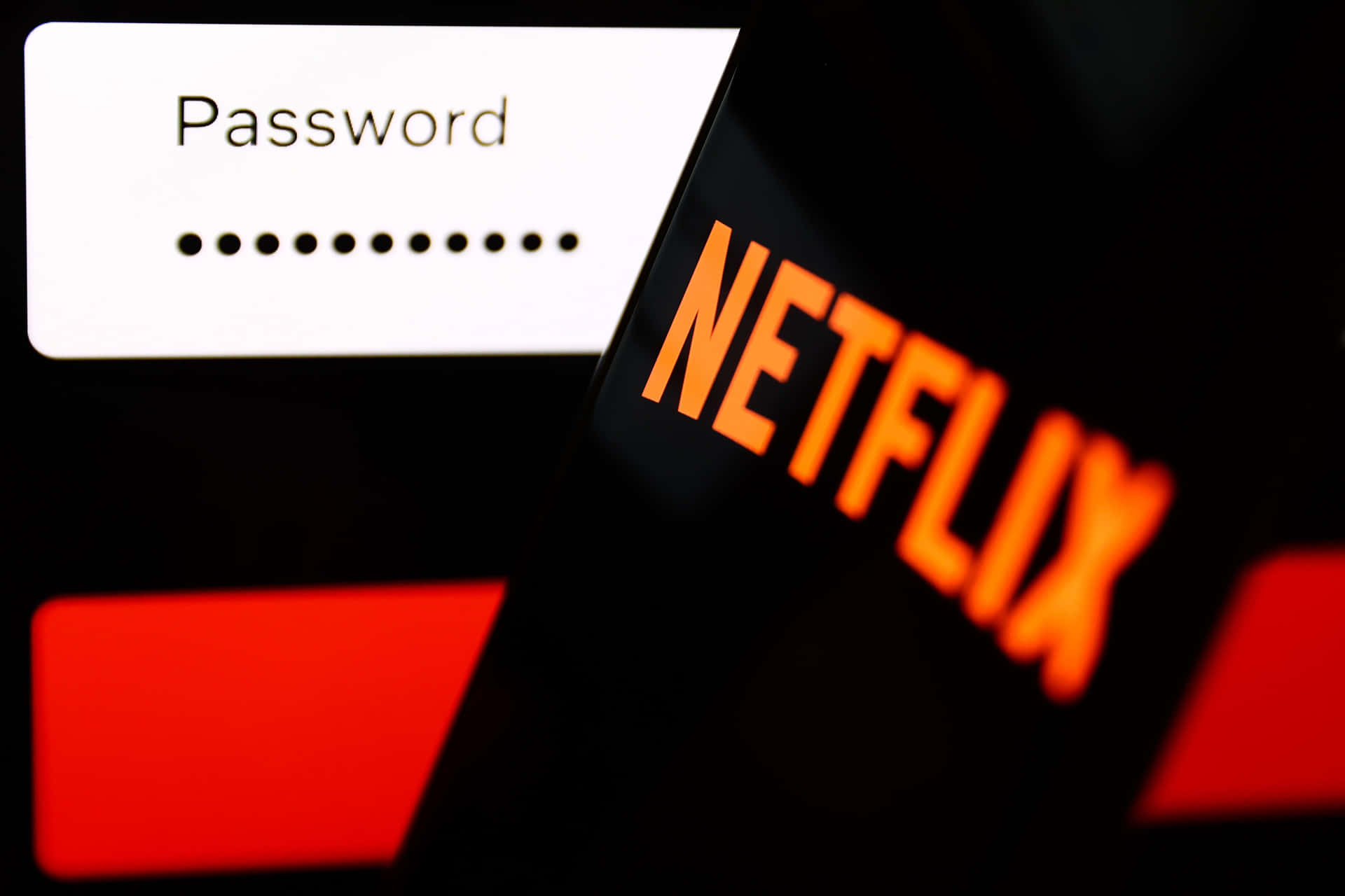 手機顯示 Netflix 登入，帶有密碼欄位和發光標誌。