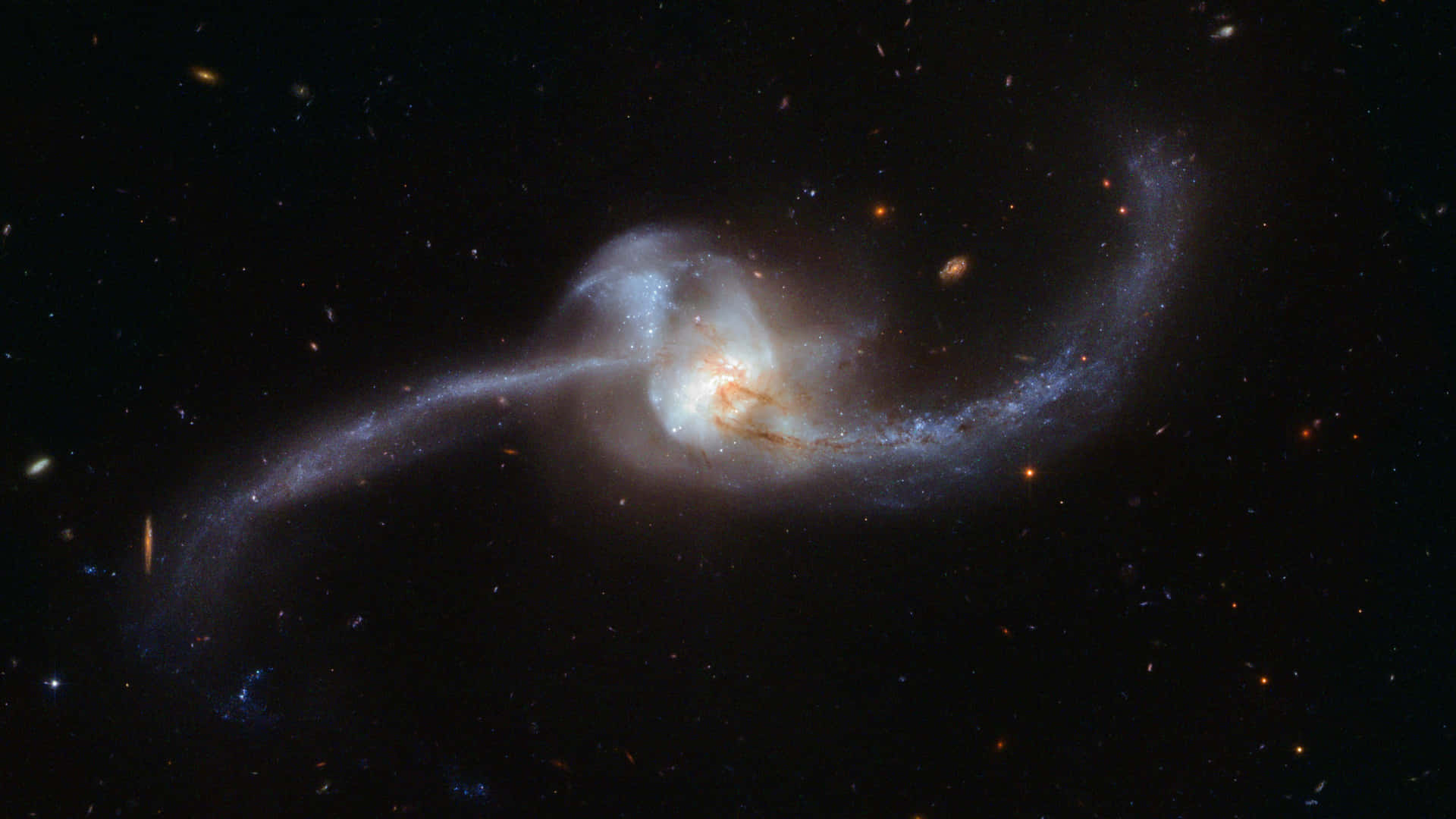 一個螺旋星系，帶有發光的旋臂和明亮的核心，在充滿恆星的宇宙虛空中旋轉。
