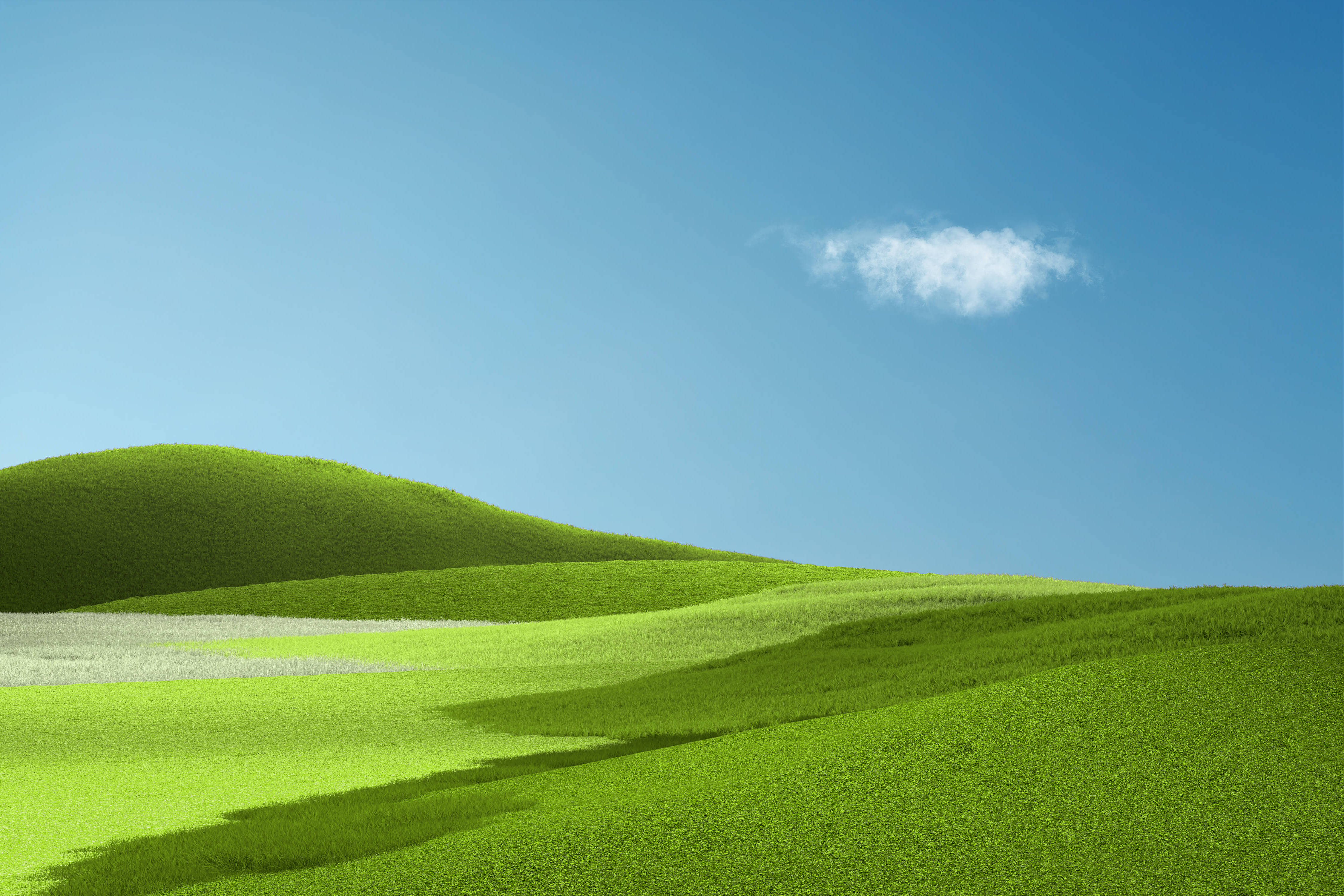 microsoft 桌布 壁紙 — 連綿起伏的翡翠綠山丘在清澈的藍天下延伸，一朵蓬鬆的白雲飄浮其上。