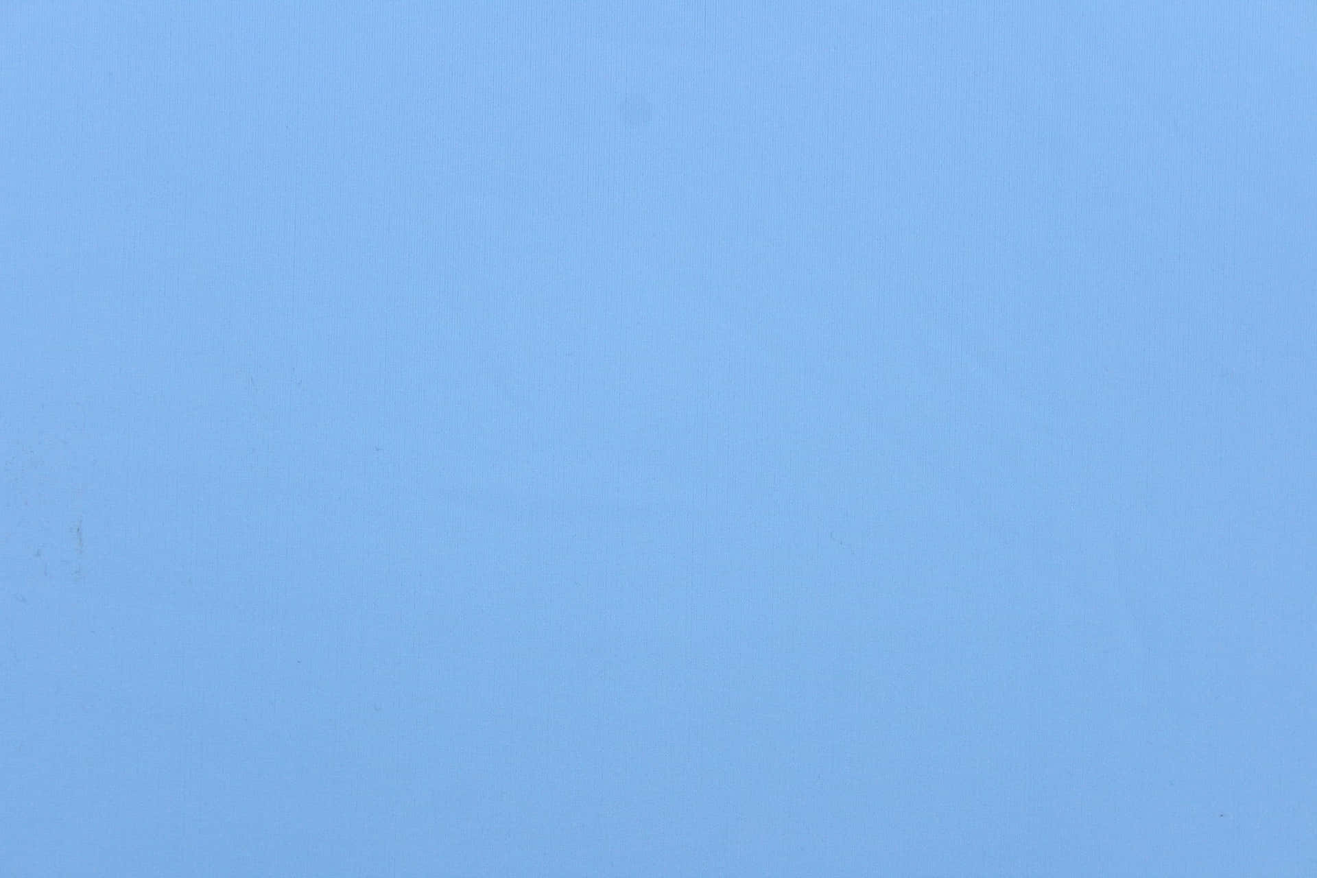 淺藍色紋理布料表面，帶有細微瑕疵。