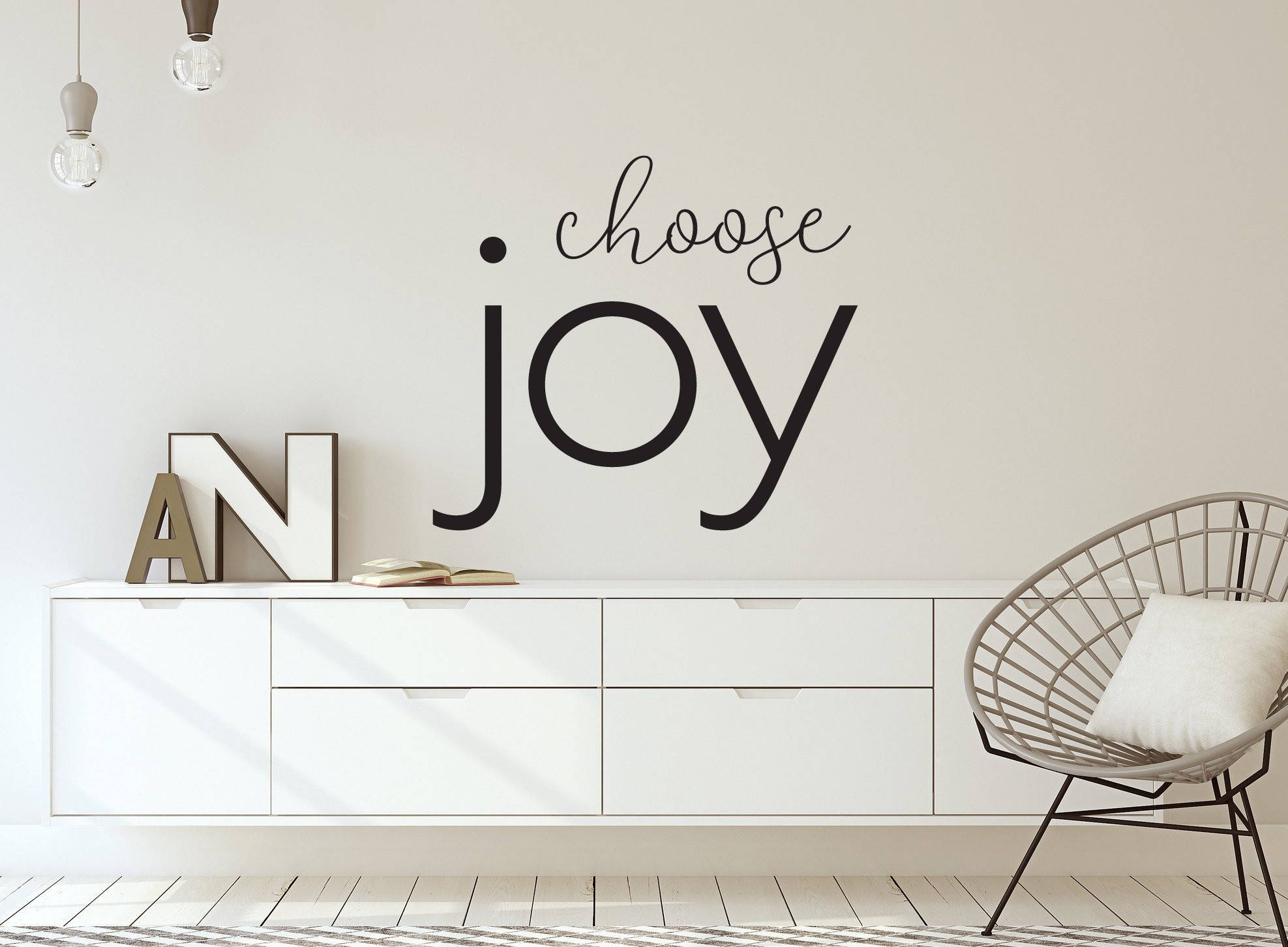 選擇歡樂壁畫 壁紙 — 簡約現代房間，白色控制台上方有「choose joy」牆貼和鐵線椅。