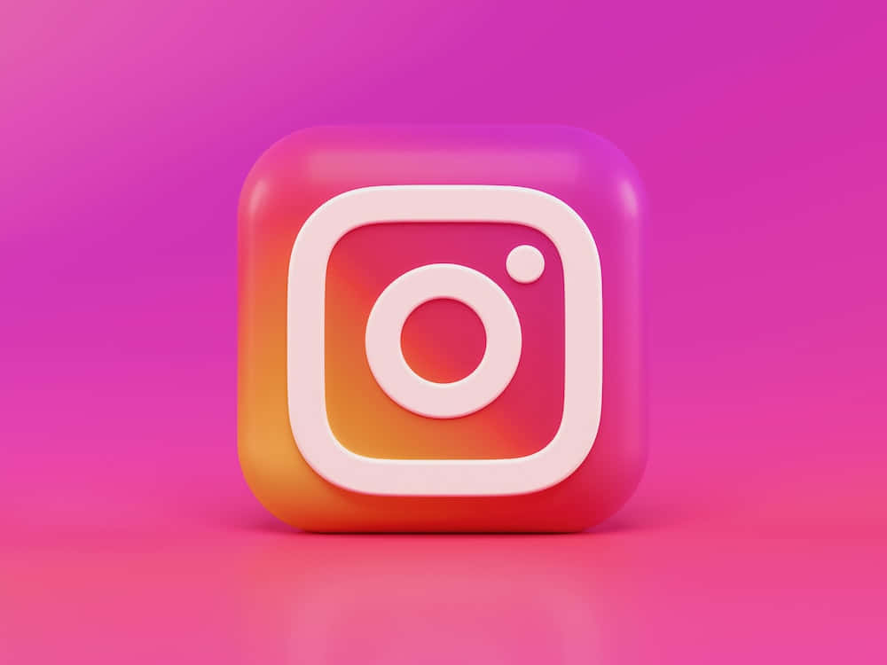 帶有漸變橙粉紅色調的光澤3D Instagram標誌圖示，背景為粉紅色。