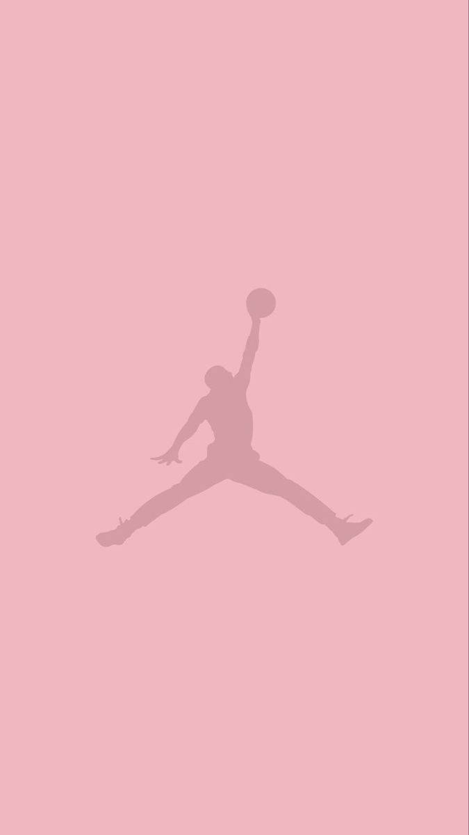 酷炫Pantone粉紅Air Jordan標誌 壁紙 — 一個極簡風格的籃球運動員剪影，正在半空中灌籃，背景為純粉紅色。