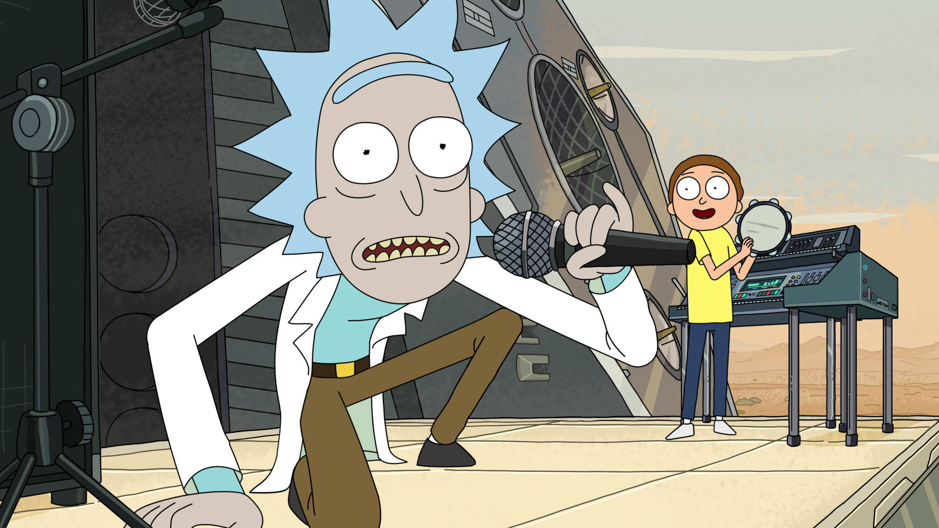 Rick Sanchez 在沙漠舞台上對著咪高峰唱歌，Morty 彈奏鍵盤。