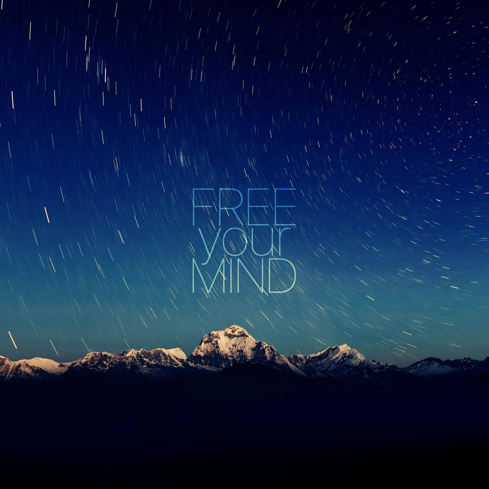星空下嘅雪山，帶有發光文字 free your mind。