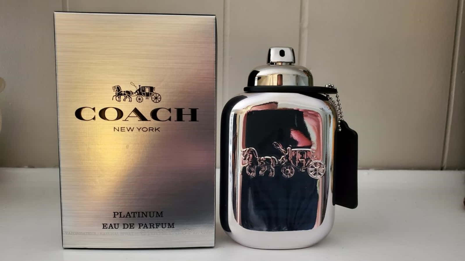 銀色Coach Platinum香水瓶和盒子，帶有馬和馬車標誌。