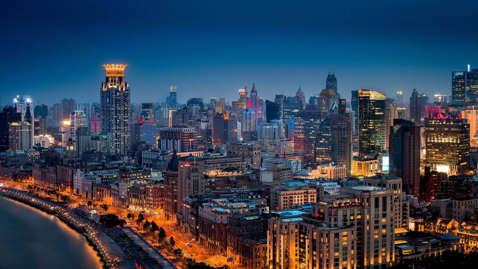 重慶藍調夜景 壁紙 — 黃昏時分充滿活力的城市天際線，閃爍的摩天大樓和海濱溫暖的路燈。