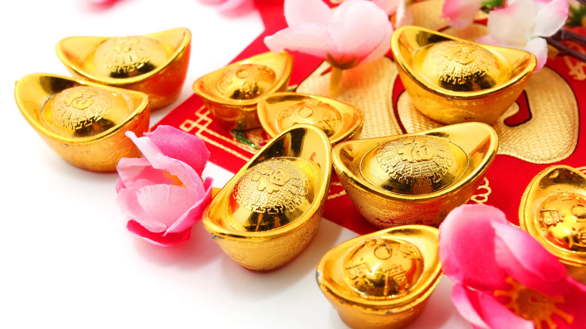 金條配粉紅花朵 壁紙 — 閃閃發光的金條散落在紅色紙上，搭配粉紅櫻花，營造節日幸運主題。