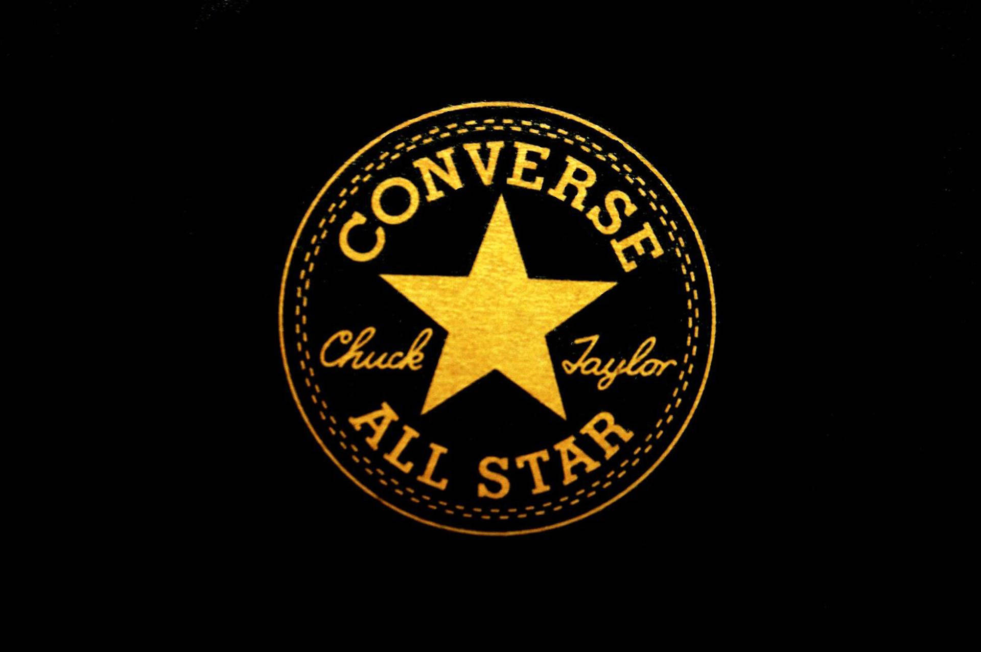 金色 Converse 標誌 壁紙 — 金色Converse Chuck Taylor All Star標誌在純黑色背景上發光，帶有縫線細節。