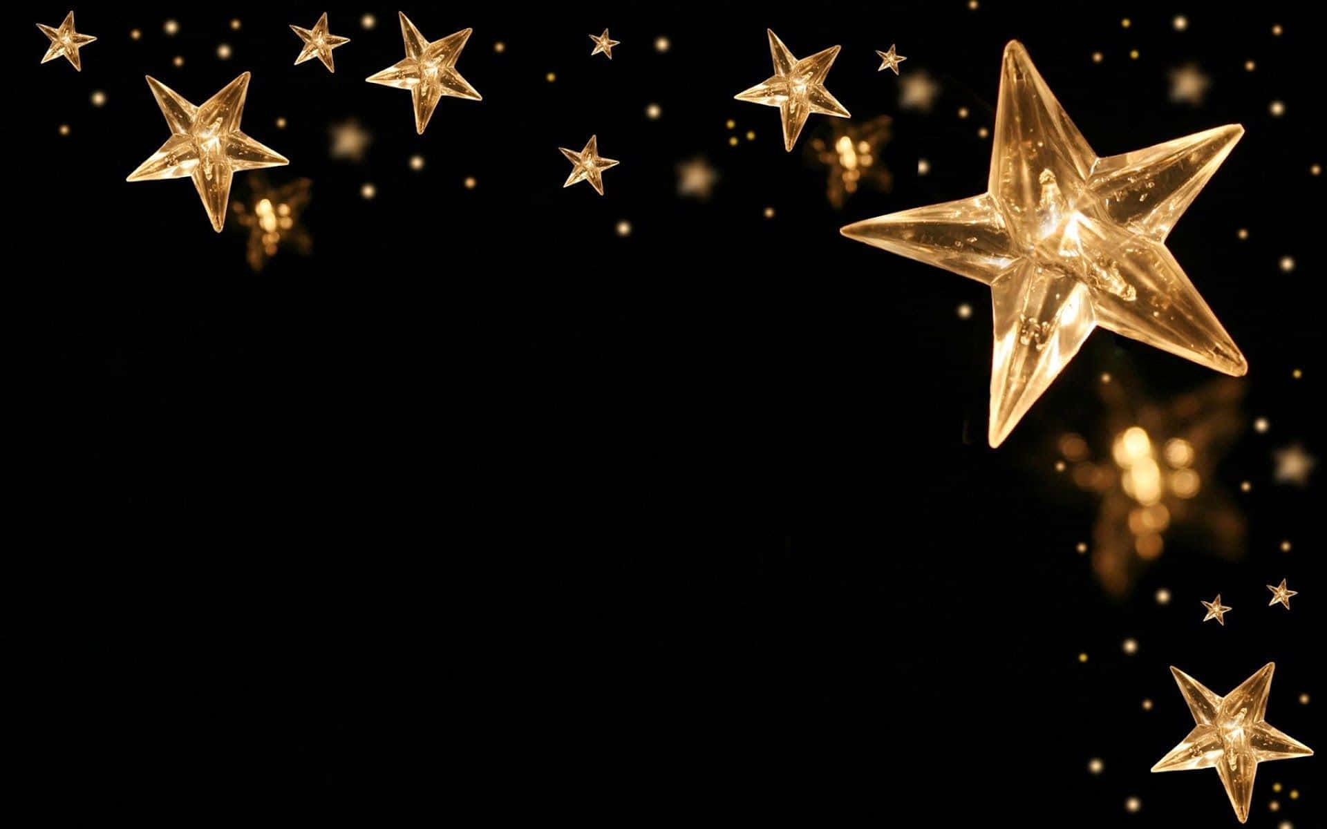 3d Star 桌布 壁紙 — 金色星形燈光在深黑色背景上閃爍，營造出節日魔幻氣氛。