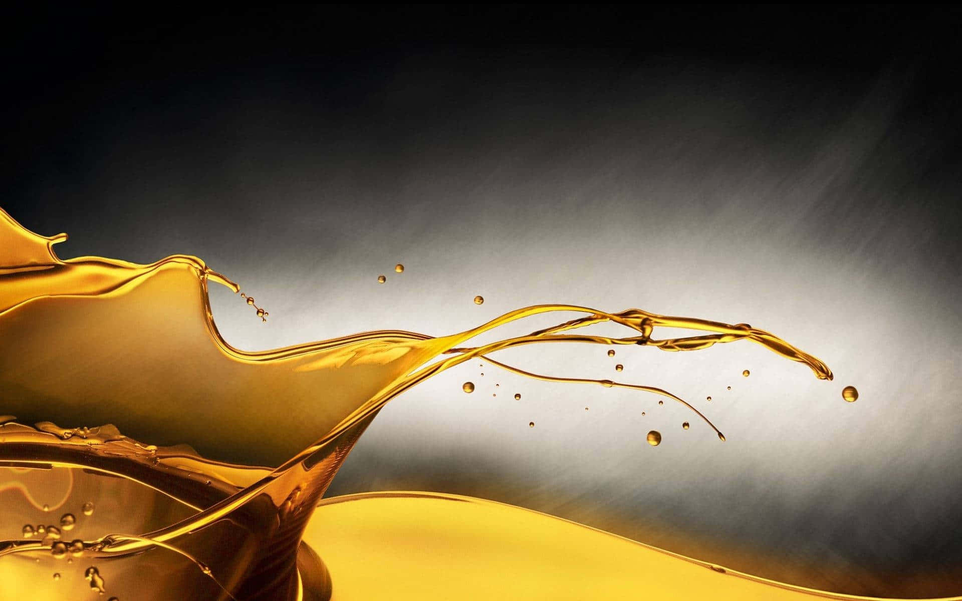 Oil 桌布 壁紙 — 金色液體動態飛濺，優雅地劃出弧線，在深色漸變背景上散落著點點水珠。