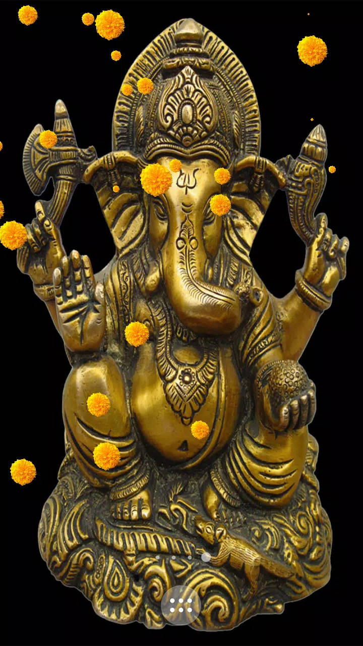 ganesh iPhone 桌布 壁紙 — 金色象神雕像飾以金盞花，黑色背景上有漂浮的花朵。
