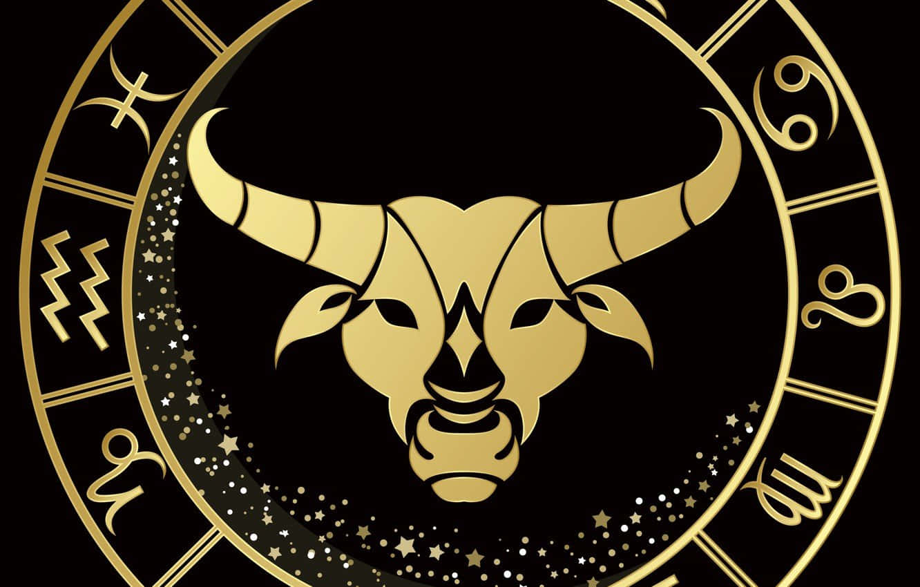 金牛座 桌布 壁紙 — 金色金牛座星座符號，帶有星光光環，置於黑色背景的圓形黃道輪中央。