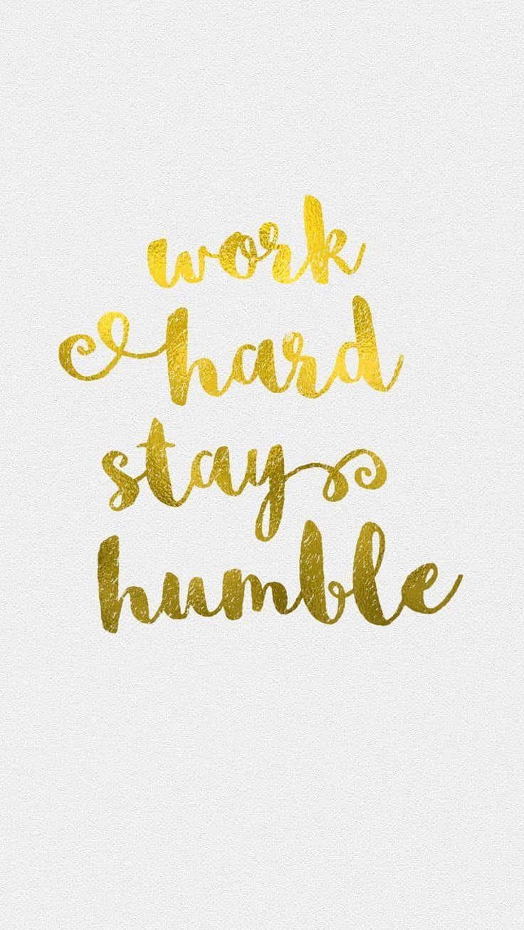 White Gold 桌布 壁紙 — 金色閃亮草書文字在紋理白色背景上寫著 work hard stay humble。