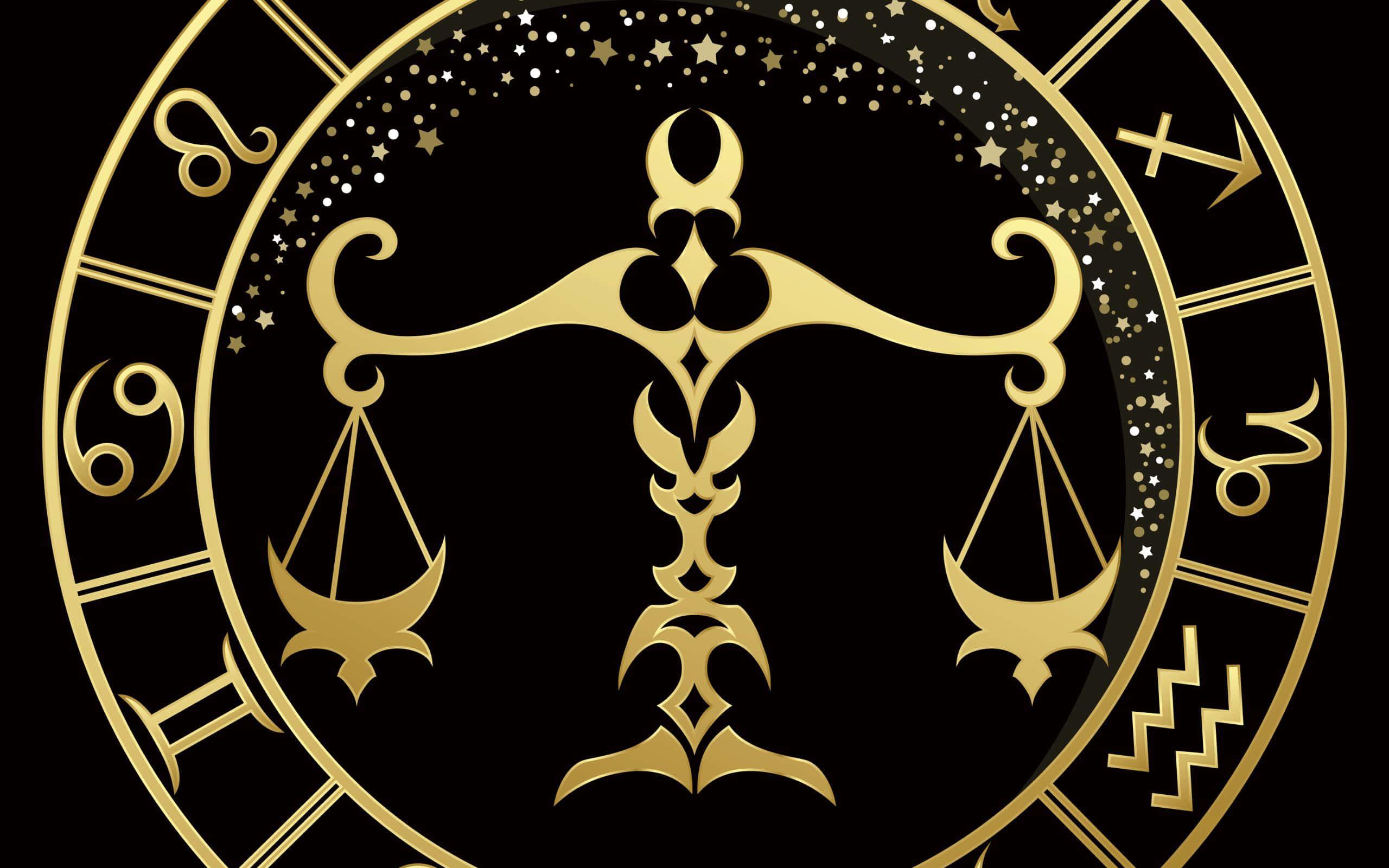 libra 桌布 壁紙 — 金色黃道輪盤，中央為天秤座天平，周圍環繞閃爍星星及占星符號，黑色背景。